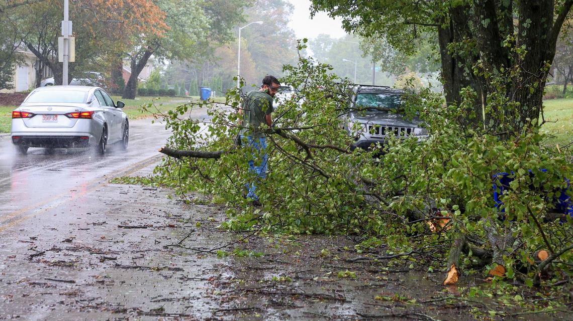 Keenon Swinford removes downed tree limbs off Montavesta Road, Friday, Sept. 27, 2024 in Lexington, Ky. Swinford said he lives across the street and was helping a neighbor after rain and high winds from Hurricane Helene brought down trees in the neighborhood.