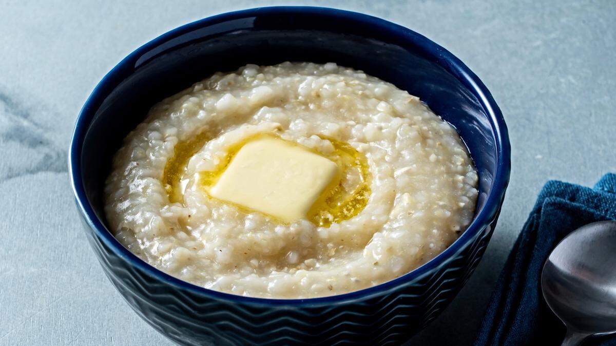Grits can be enjoyed all on their own in a bowl topped with butter.