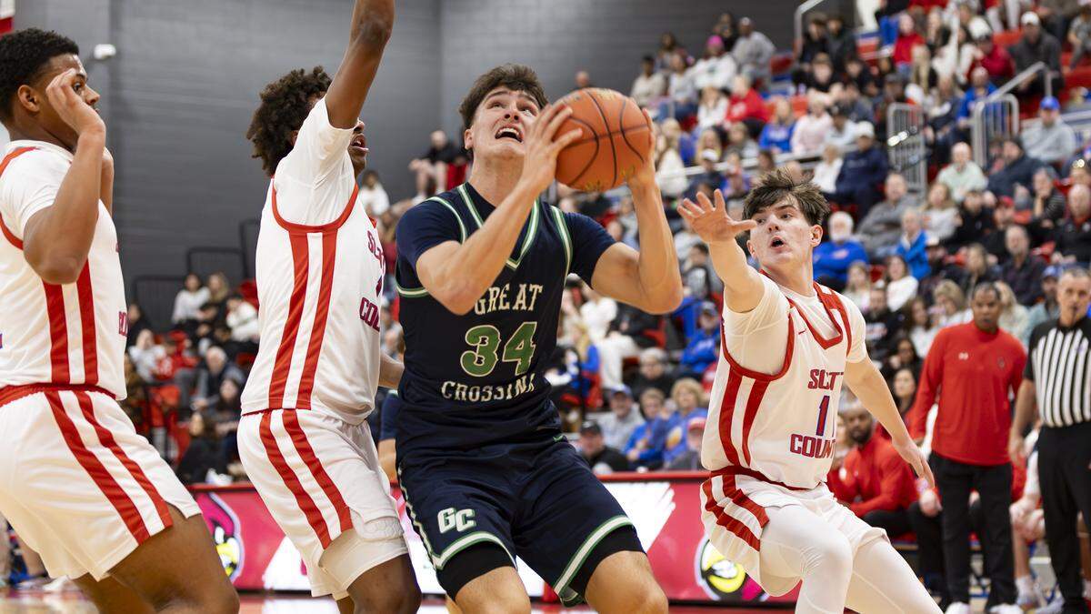 Great Crossing’s Brady Orem (34) went up for a basket amid Scott County defenders, from left, Caelin Hunter, Tidiane Faye and Parker Sanders during the Warhawks’ 69-51 win at Coach Billy Hicks Gymnasium on Saturday in Georgetown.