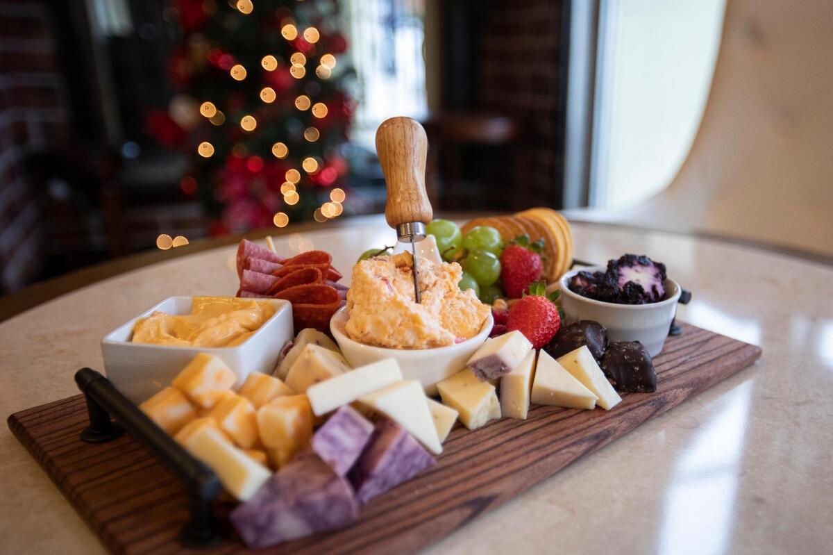 Shellie Hancock prepares charcuterie boards at the Board Room Charcuterie and Wine in Morehead, Ky., Tuesday, December 6, 2022. Hancock’s passion project led to Morehead’s only charcuterie restaurant. During COVID Hancock made charcuterie boards for parties, expanded on social media, eventually opening a brick and mortar store front.
