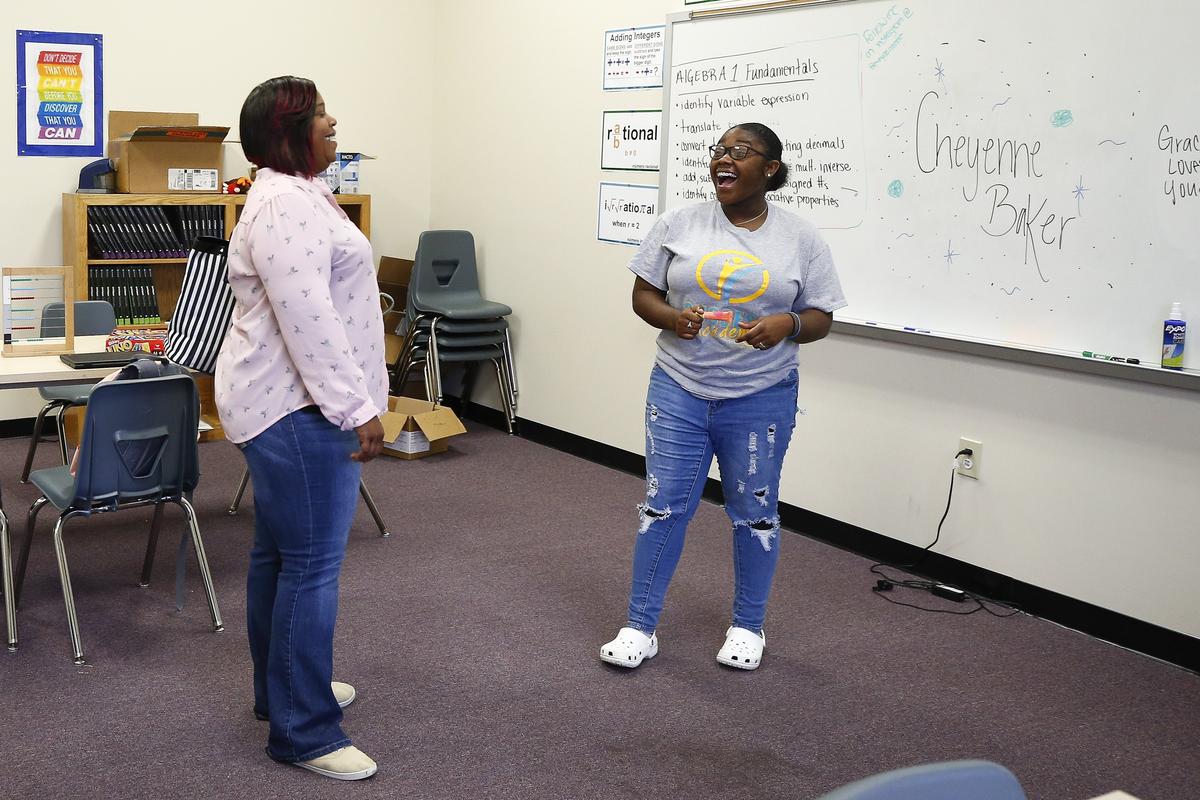 Algeria Johnson laughed with her daughter Tykiya Jackson, 16,  as they toured classroom Thursday during an open house at Success Academy in Lexington.