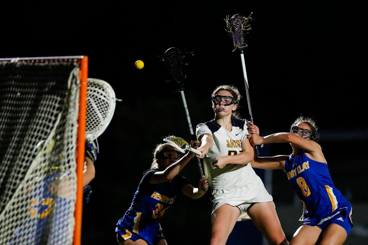 Sayre’s Isabelle Brogden (21) attempts to score on Henry Clay during the Girls Commonwealth Lacrosse League East finals at the Sayre Athletic Complex in Lexington on Wednesday.