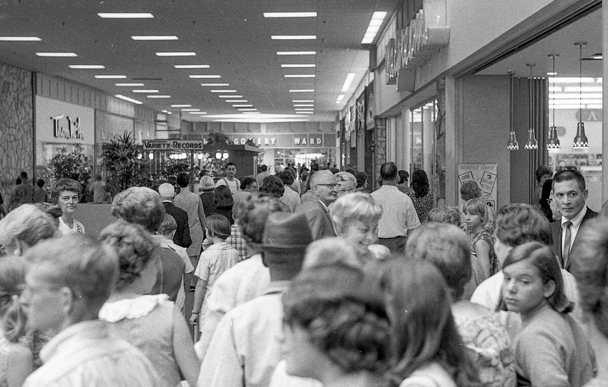Shoppers crowd the inside of Turfland Mall on opening day, Aug. 24, 1967. Lexington’s first mall opened with 35 stores, including major tenants McAlpin’s and Montgomery Ward, seen in the back of the image. At right is Walgreen’s, which had a lunch counter, and to the left is Thom McAn Shoes. A Variety Records kiosk is in the middle of the picture. The mall had fountains, floral displays, animal sculptures, a movie theater and giant skylights to let in natural light. There was also a 150-seat auditorium that was used by local organizations, free of charge.