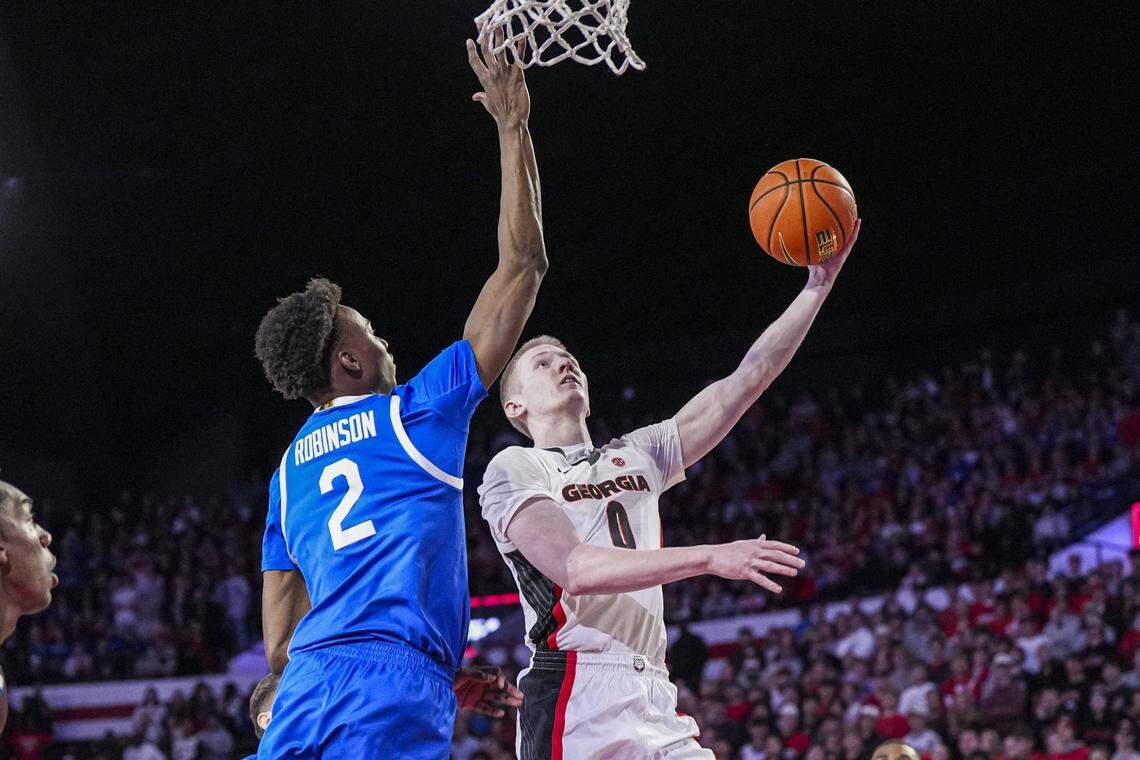 Jan 7, 2025; Athens, Georgia, USA; Georgia Bulldogs guard Blue Cain (0) shoots against Kentucky Wildcats guard Jaxson Robinson (2) during the first half at Stegeman Coliseum. Mandatory Credit: Dale Zanine-Imagn Images