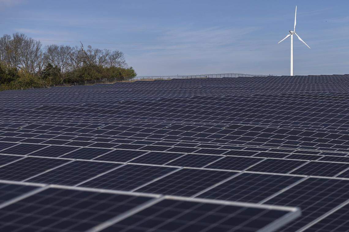 A wind turbine and solar panels are photographed at LG&E and KU's Renewable Integration Research Facility at the E.W. Brown Generating Station in Mercer County.