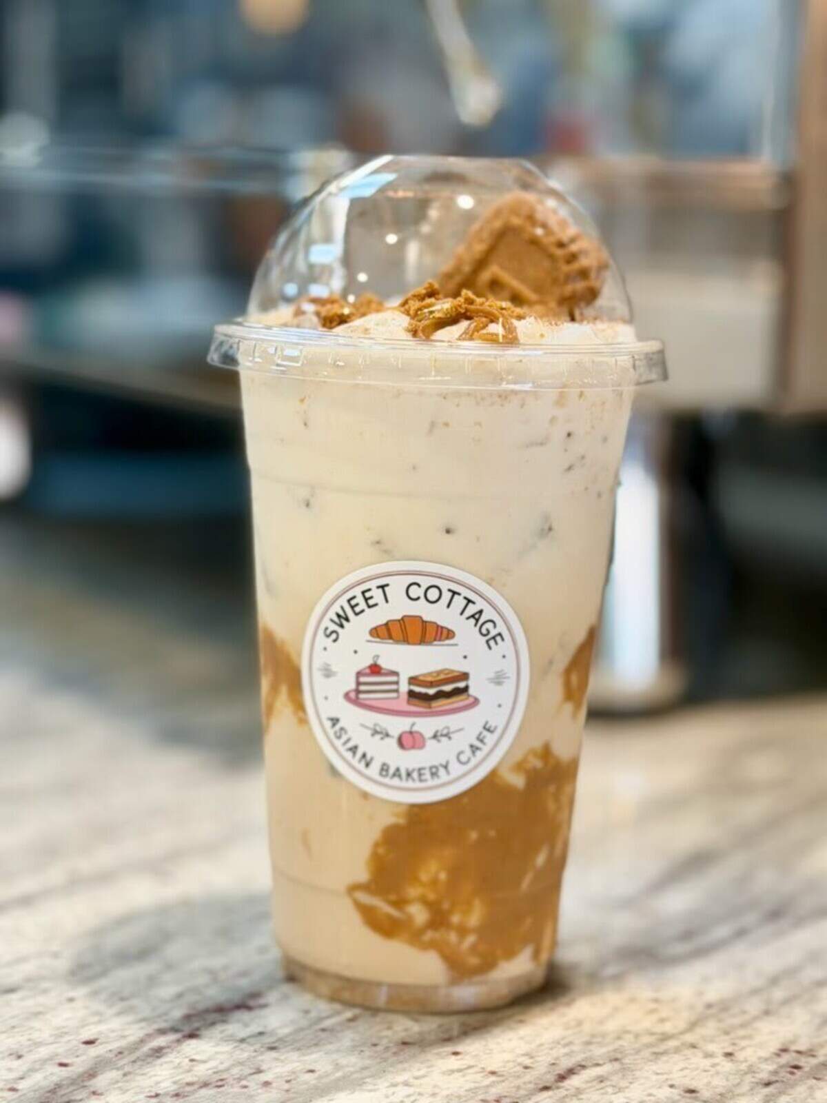 Sweet Cottage Asian Bakery Cafe offers a variety of specialty drinks, including Biscoff Latte made with espresso, milk, Biscoff cookie butter and topped with cold foam, caramel drizzle and cookie pieces.