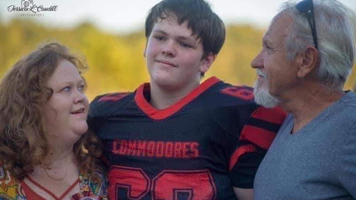 Aaron “Mick” Crawford 18, a Knott Central High School football player, died Sunday. Mickey, photographed with his parents Ronda and David Crawford, was helping Eastern Kentucky flood victims when he fell ill and later died.