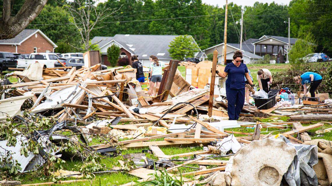 Members of the community and from surrounding areas assist with clean-up efforts in the Sunshine Hills subdivision following Saturday’s deadly tornado storm in Laurel County on May 17, 2025, in London, Ky.