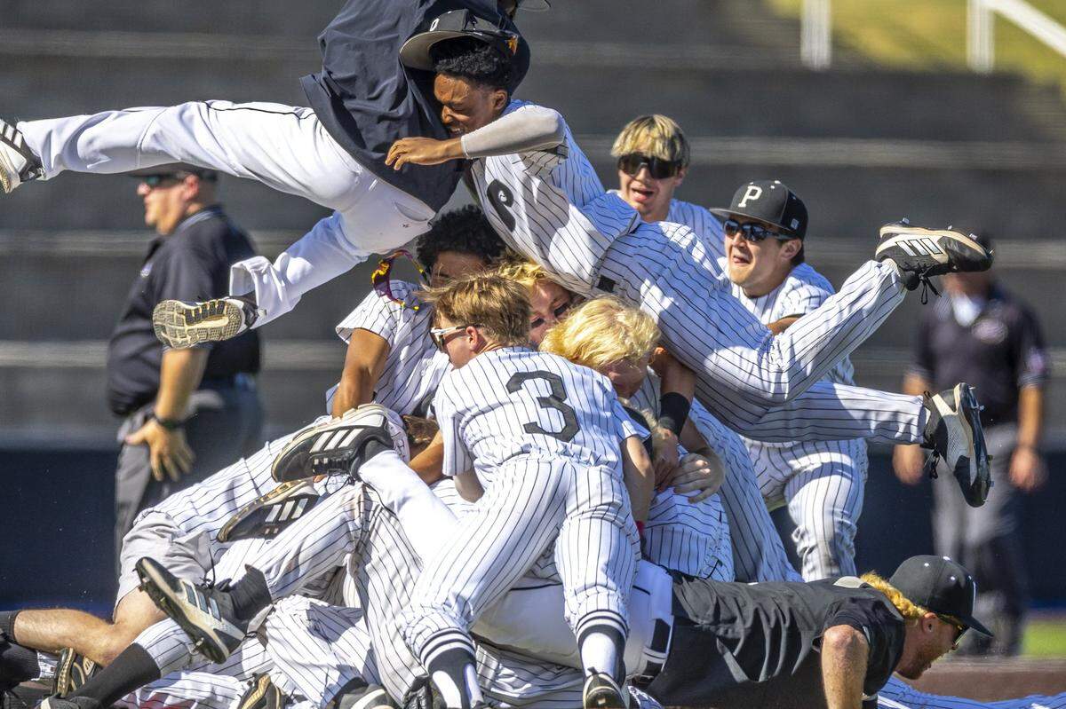 Pleasure Ridge Park players celebrate after winning the state baseball championship with a 4-1 win against McCracken County at Kentucky Proud Park.