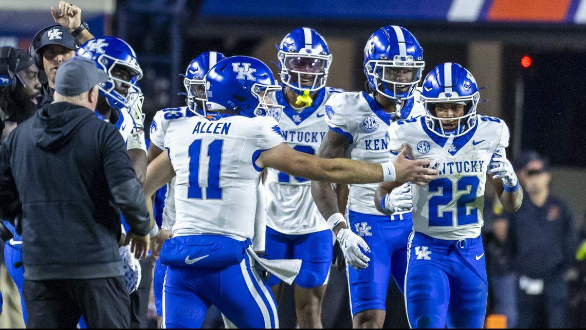 Kentucky wide receiver Cameron Miller (22) celebrates with his teammates after he forced a fumble to help preserve UK’s 10-3 win against Auburn.