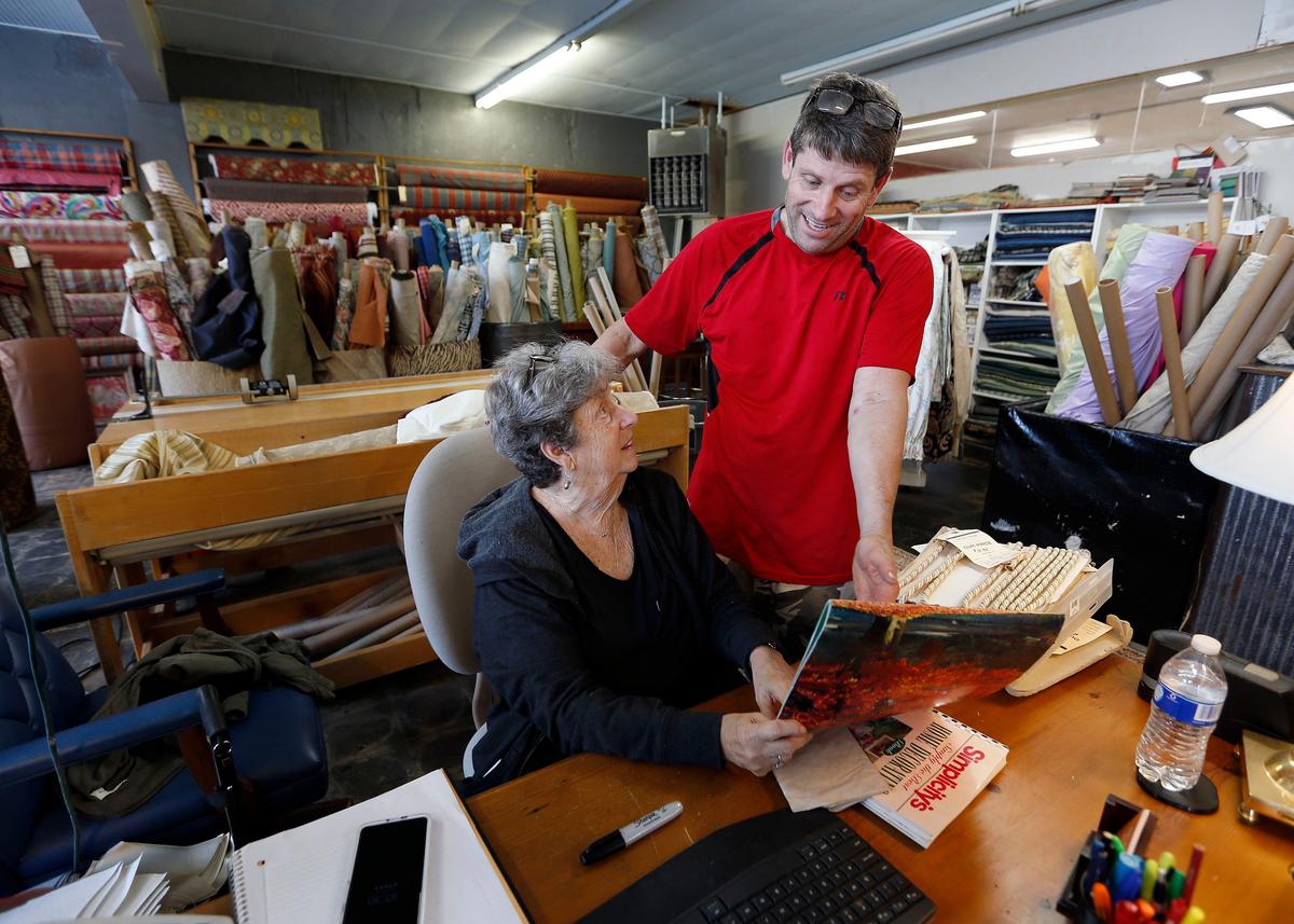 Jere Clancy and his mom Judy Clancy talked at their shop, Texture Design Fabrics and Upholstery, 930 Winchester Road. This section of Winchester Road and nearby Liberty Road has become a destination for antique and home decor shoppers.