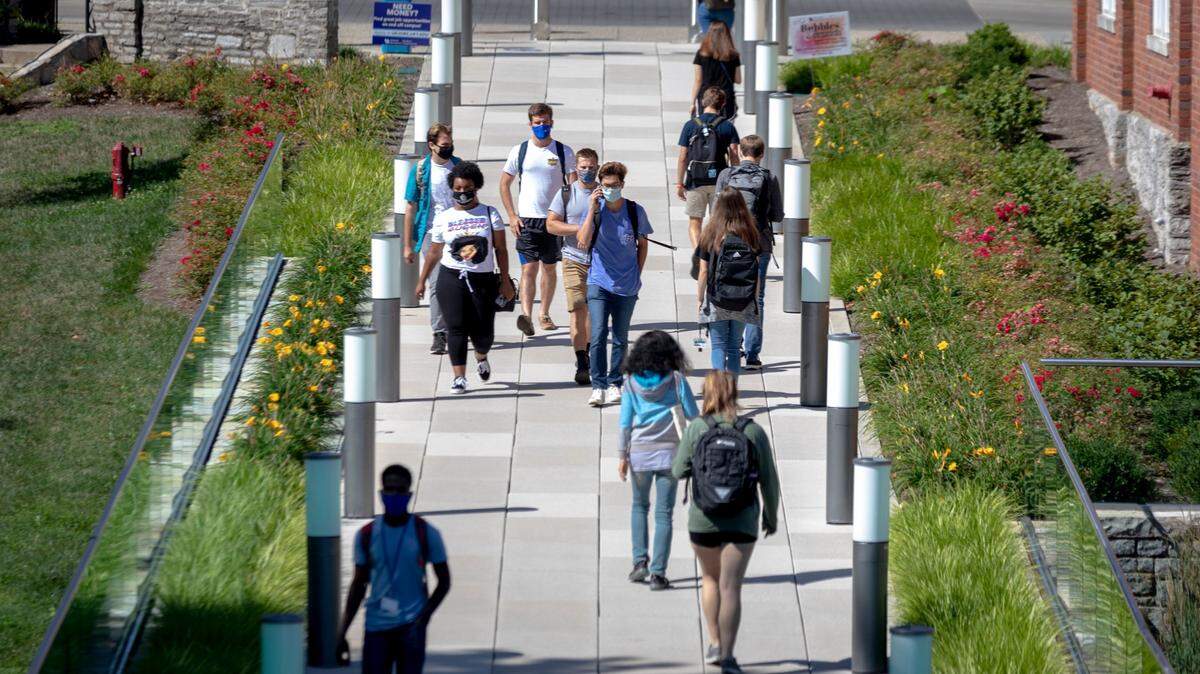 Students make their way around campus during the first day of classes at the University of Kentucky in Lexington, Ky., Monday, August 17, 2020. Signs have been posted encouraging students to stay to the right side of sidewalks and keep their social distance.
