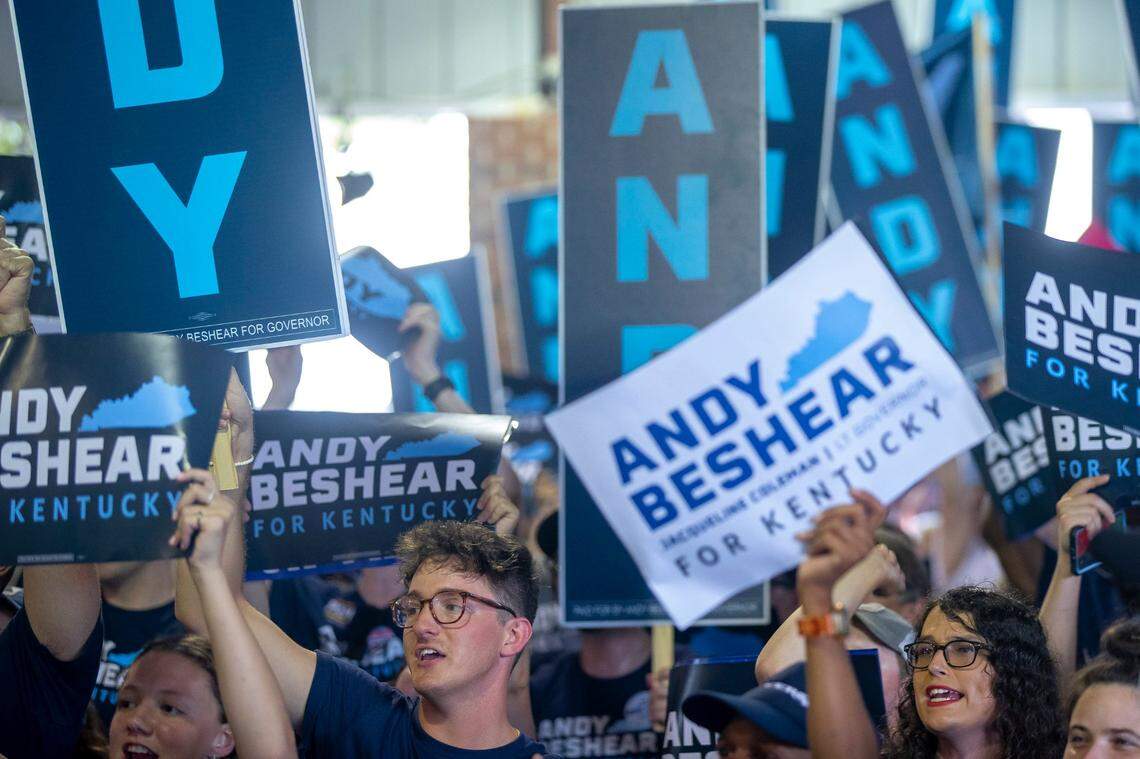 Kentucky Gov. Andy Beshear supporters hold signs and cheer during the annual St. Jerome Fancy Farm Picnic in Fancy Farm, Ky., on Saturday, Aug. 5, 2023.