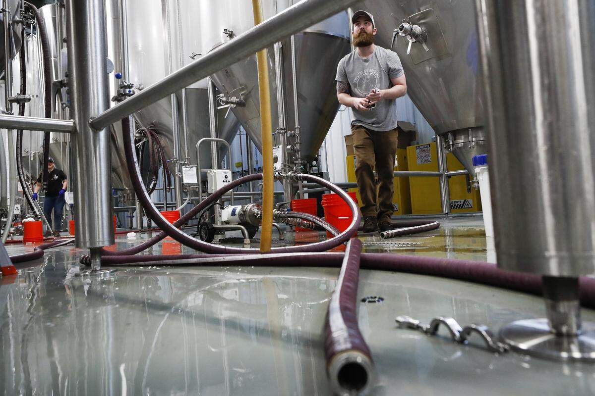 Country Boy Brewing Asst. Production Manager Trevor Austin worked to clean a fermenter April 24 at Country Boy Brewing in Georgetown.