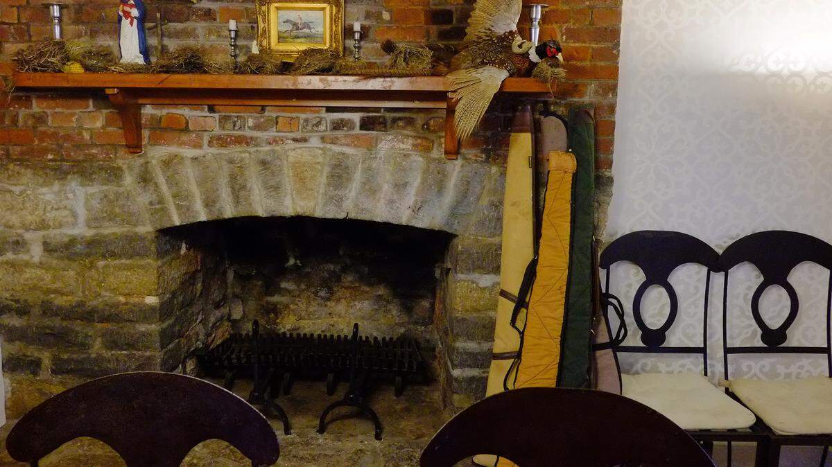 The dining area in the kitchen features an original stone fireplace. Owens and his wife have put the home and 31 acres on the market because they want less house and more land.