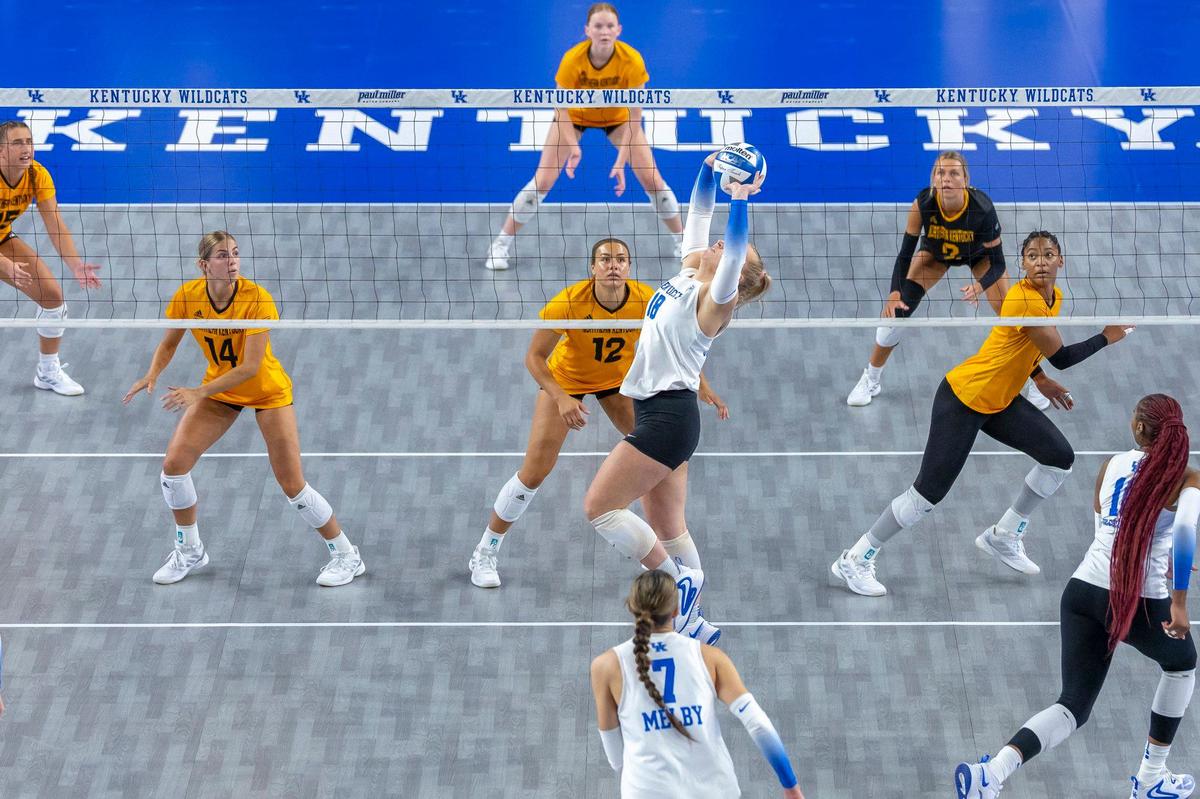Kentucky’s Lane Jenkins, center, sets the ball during a volleyball match against Northern Kentucky at the newly renovated Memorial Coliseum on Friday.