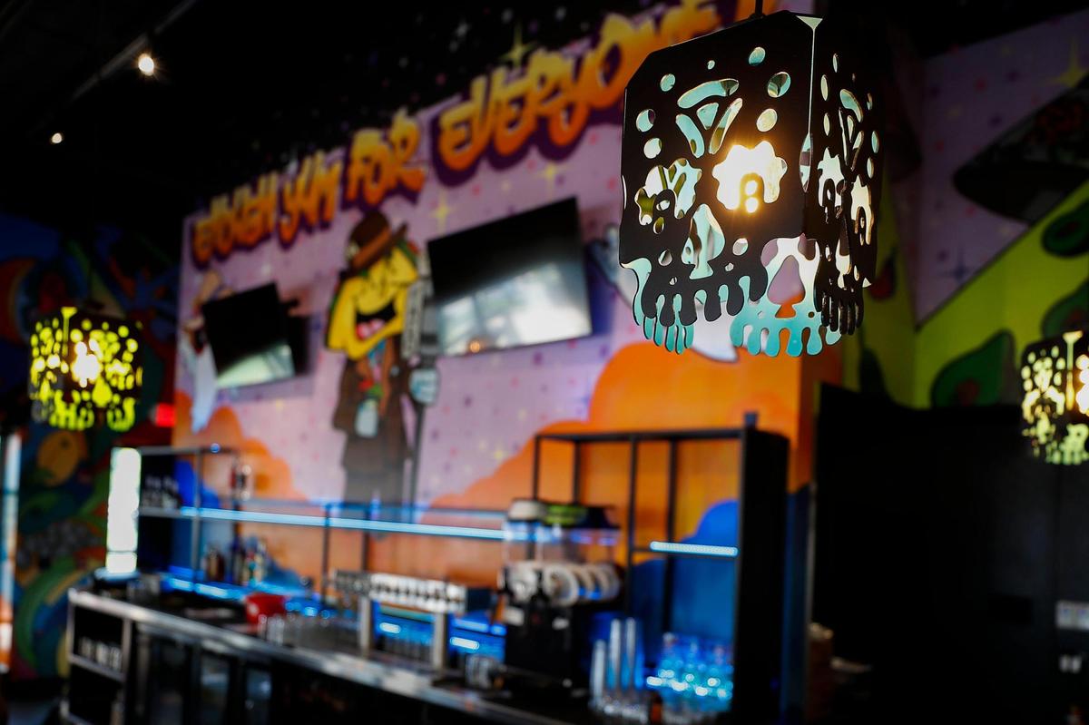 Lanterns hang above the bar at Condado Tacos at The Summit at Fritz Farm. Each location is decorated special with murals.