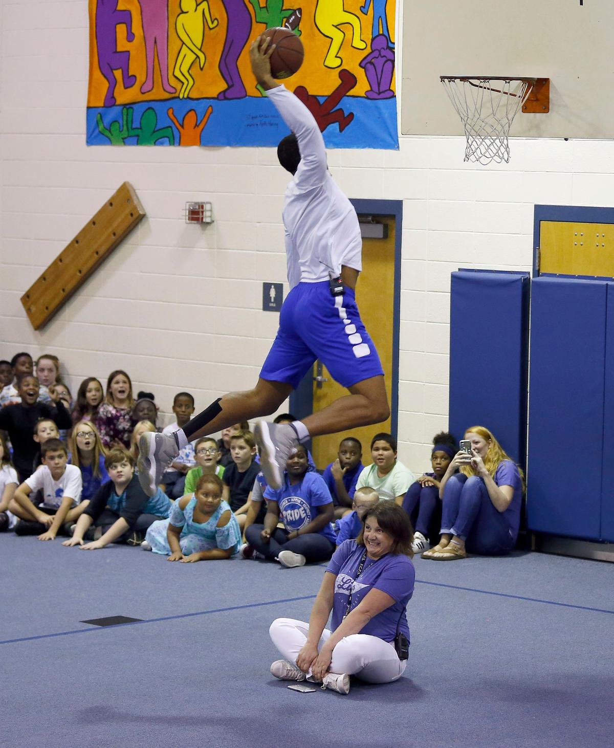 UK’s Keldon Johnson dunked over principal Jennifer Hutchison as nine members of the Kentucky men’s basketball team visited Picadome Elementary School Friday afternoon. The Wildcats delivered packed lunches to the school as a part of UK Athletics’ God’s Pantry program and then participated in physical education activities with the students.