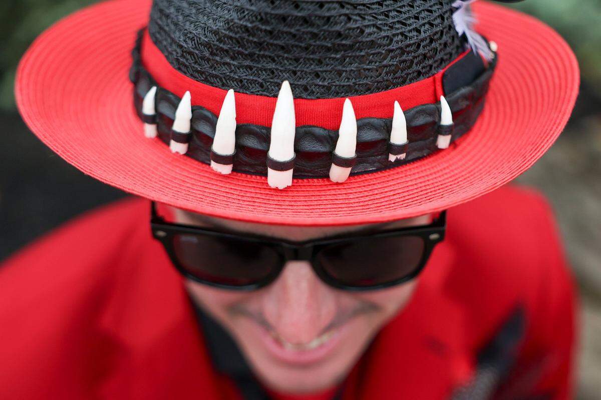 Antonio Alvarez wore a red suit featuring a hat with a band of crocodile teeth and hide during Kentucky Derby 151 at Churchill Downs May 3, 2025.&nbsp;&nbsp;