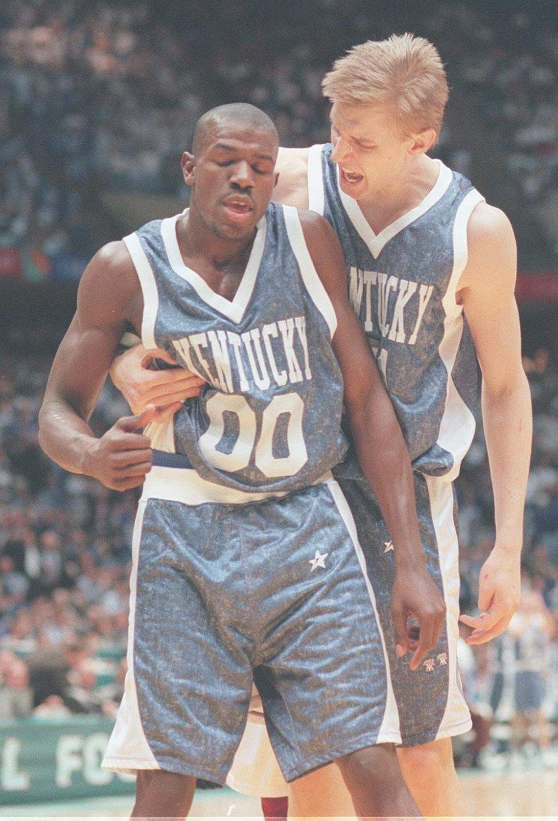 Kentucky basketball players Mark Pope, right, and Tony Delk hug after Delk was fouled during an NCAA Tournament Final Four game against UMass on March 30, 1996, in East Rutherford, New Jersey. Pope became UK’s current coach in April 2024.