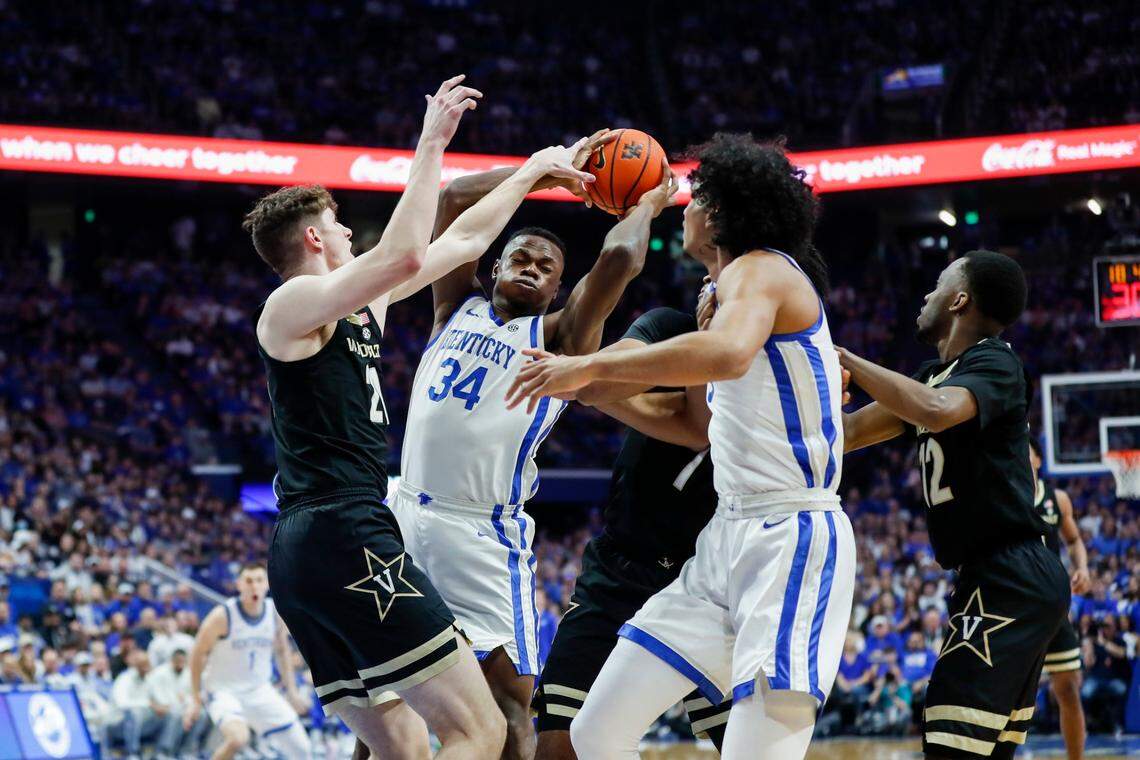 Kentucky’s Oscar Tshiebwe (34) grabs a rebound against Vanderbilt’s Liam Robbins (21) during Wednesday’s game at Rupp Arena. Tshiebwe finished with 21 points and 20 rebounds.