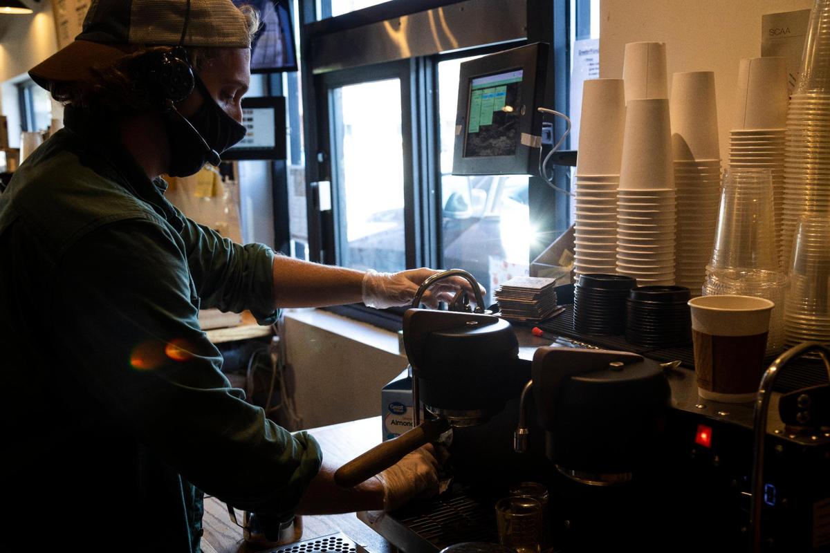 Eli Clapper makes drinks behind the bar Oct. 14 at Purdy’s Coffee Bill Hill location in Richmond.