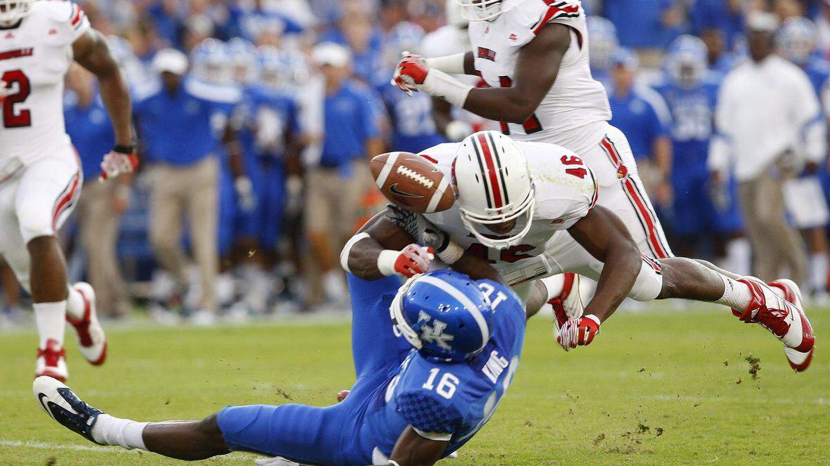 Louisville linebacker Dexter Heyman (46) forced a fumble by Kentucky's La'Rod King the first half of the Cardinals' 24-17 victory last season.      