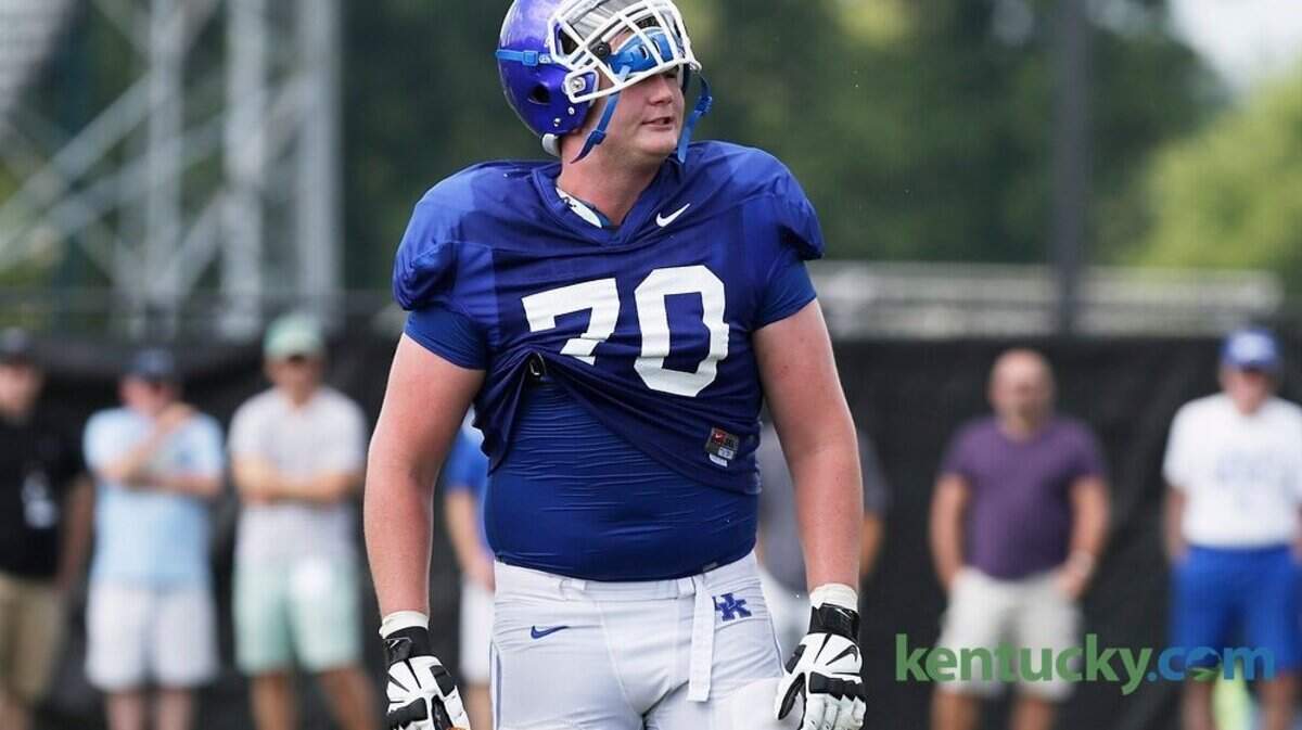 Kentucky Wildcats offensive tackle Jordan Swindle (70) pumped up the team during open football practice at the University of Kentucky in Lexington, Ky., on Aug. 12, 2014.  Photo by Pablo Alcala | Staff