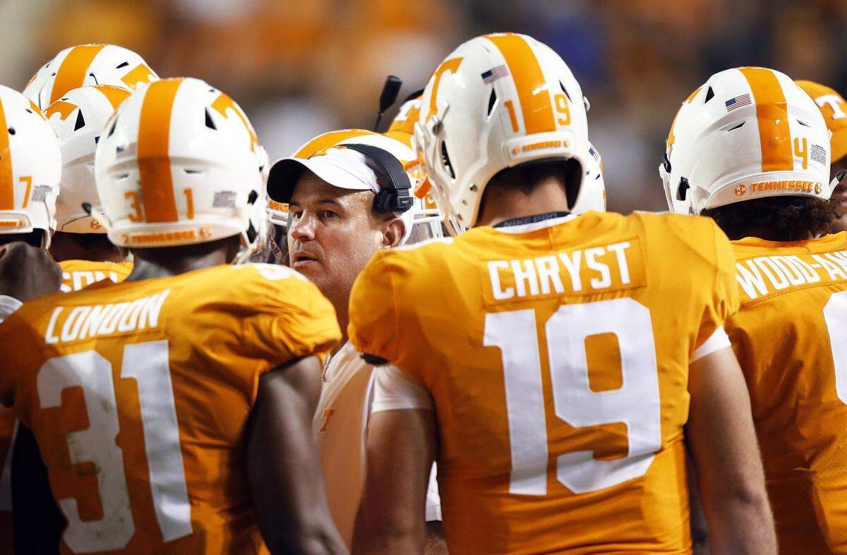 Tennessee Coach Jeremy Pruitt, center, is now 15-16 as Volunteers head man, and 12 of the 16 defeats have been by 20 points or more.