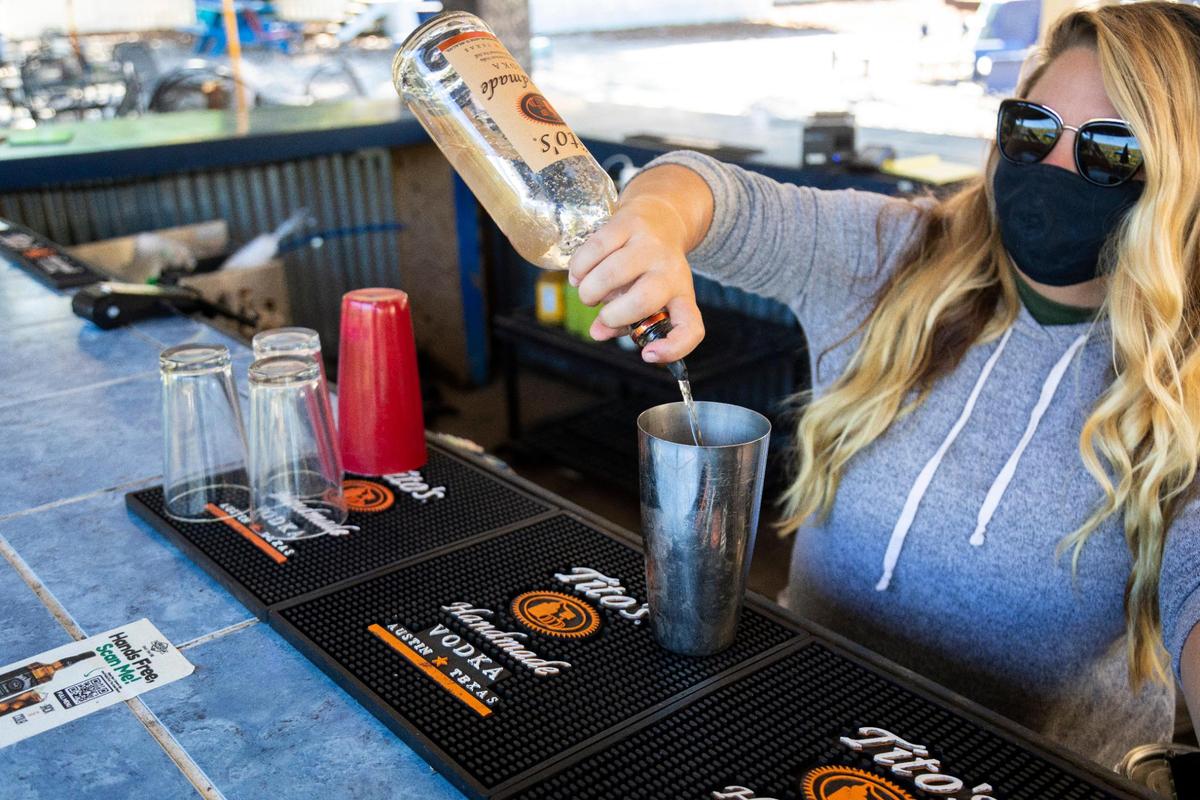 Haylee Walters pours drinks Sept. 30 at the bar of Proud Mary BBQ in Lexington.