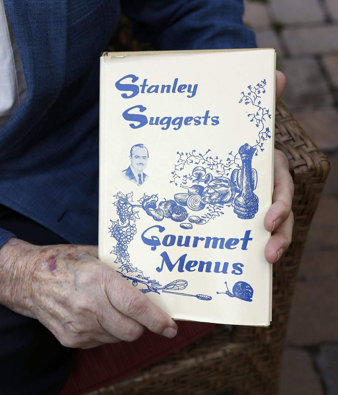 Stanley Demos, who owned the fine-dining Coach House for years, was photographed holding his cookbook, in Lexington, Ky., Friday, September 27, 2013. Demos shared his dining insights with a newspaper column, a cooking show on TV and several published cookbooks over the years.