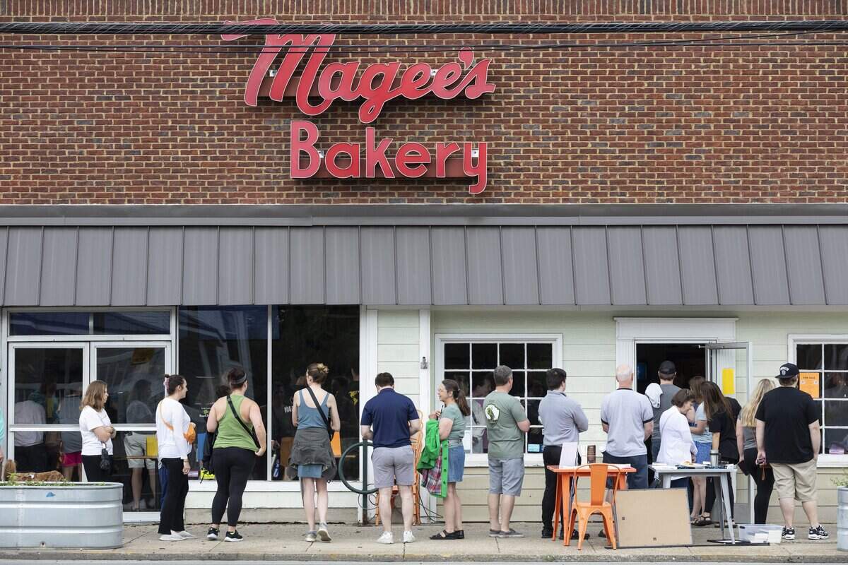 Patrons lined up around the corner of South Ashland and Main Street to try and purchase bakes goods on the last day of business for Magee's Bakery in Lexington, Ky., Saturday, May 13, 2023. The owner of the popular Lexington bakery said he plans to reopen in the fall, likely in October.