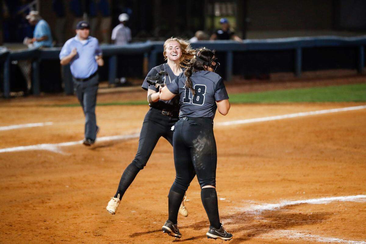 Caroline Pitcock (27) celebrates with Layla Ogden (18) after the final out of South Warren’s 8-0 win over Highlands on Saturday night.