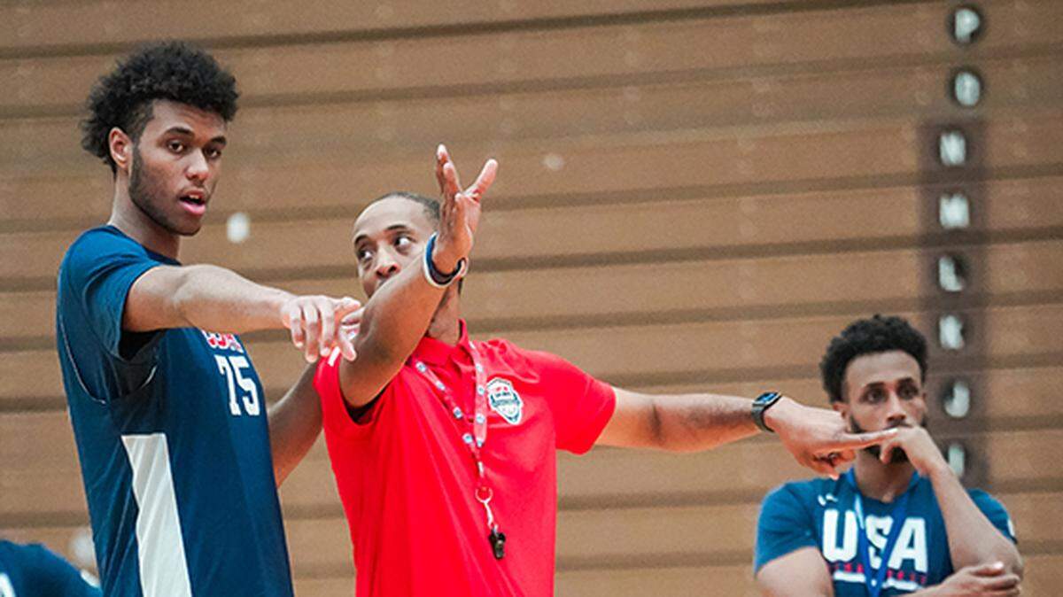 Efton Reid, left, takes instruction at a major USA Basketball camp in Colorado Springs in October.