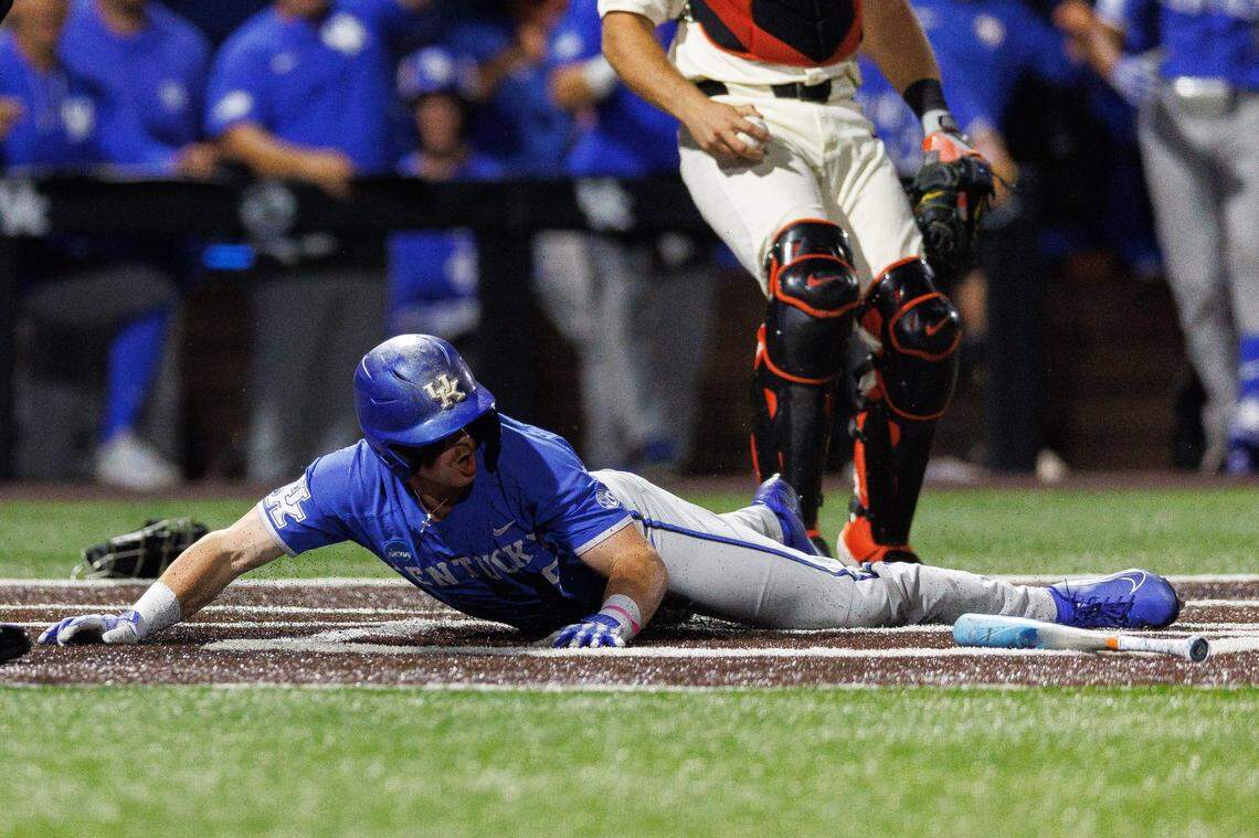 Jun 9, 2024; Lexington, KY, USA; Kentucky Wildcats outfielder Nolan McCarthy (19) slides in safe at home on a wild pitch during the seventh inning against the Oregon State Beavers at Kentucky Proud Park. Mandatory Credit: Jordan Prather-USA TODAY Sports