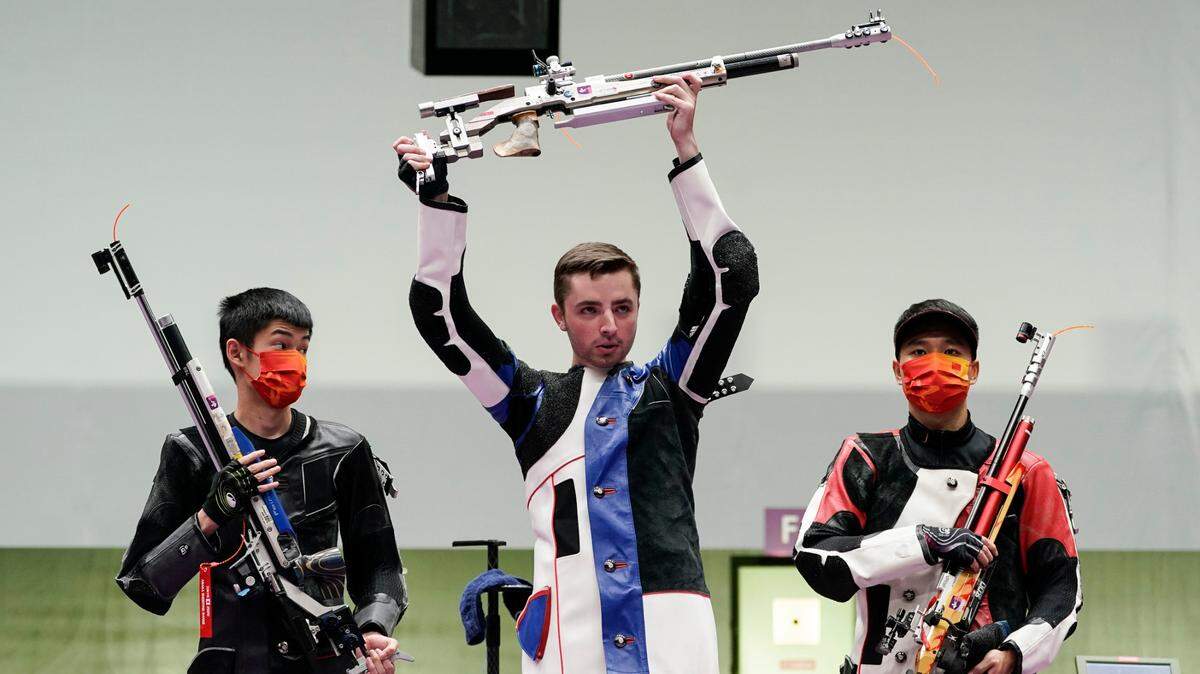 Silver medalist Sheng Lihao of China, left, gold medalist Will Shaner of the United States, and bronze medalist Yang Haoran of China celebrated after the men’s 10-meter air rifle at the Asaka Shooting Range at the Summer Olympics in Tokyo.