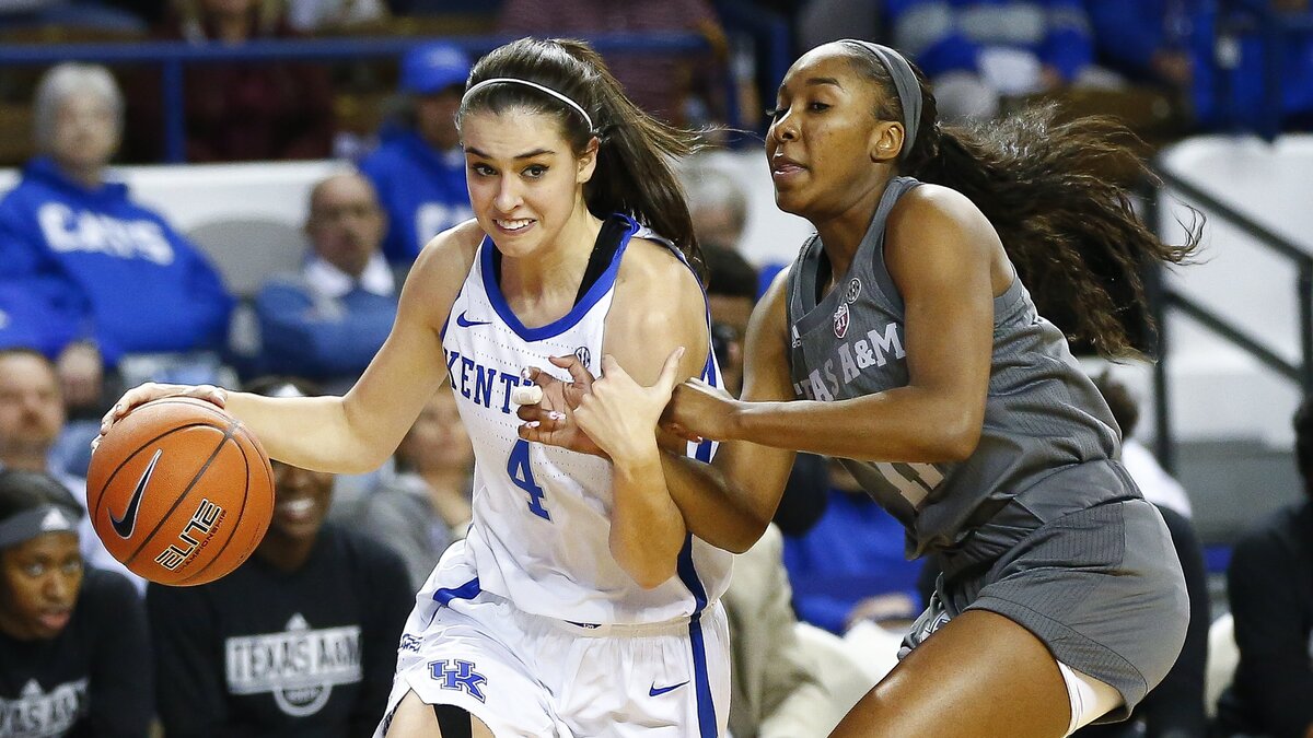 Kentucky Wildcats guard Maci Morris (4) dribbled past Texas A&M Aggies guard Kayla Wells (11) during their game Thursday at Memorial Coliseum in Lexington.