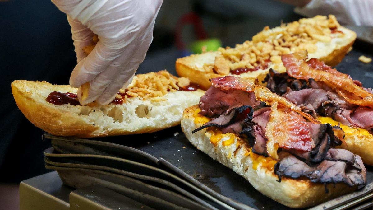 The Rushmore sandwich is made with toasted ciabatta bread, freshly sliced roast beef, Dad’s homemade chipotle cheddar cheese spread, BBQ sauce, bacon fried onion straws and is served with beer cheese sauce for dipping.