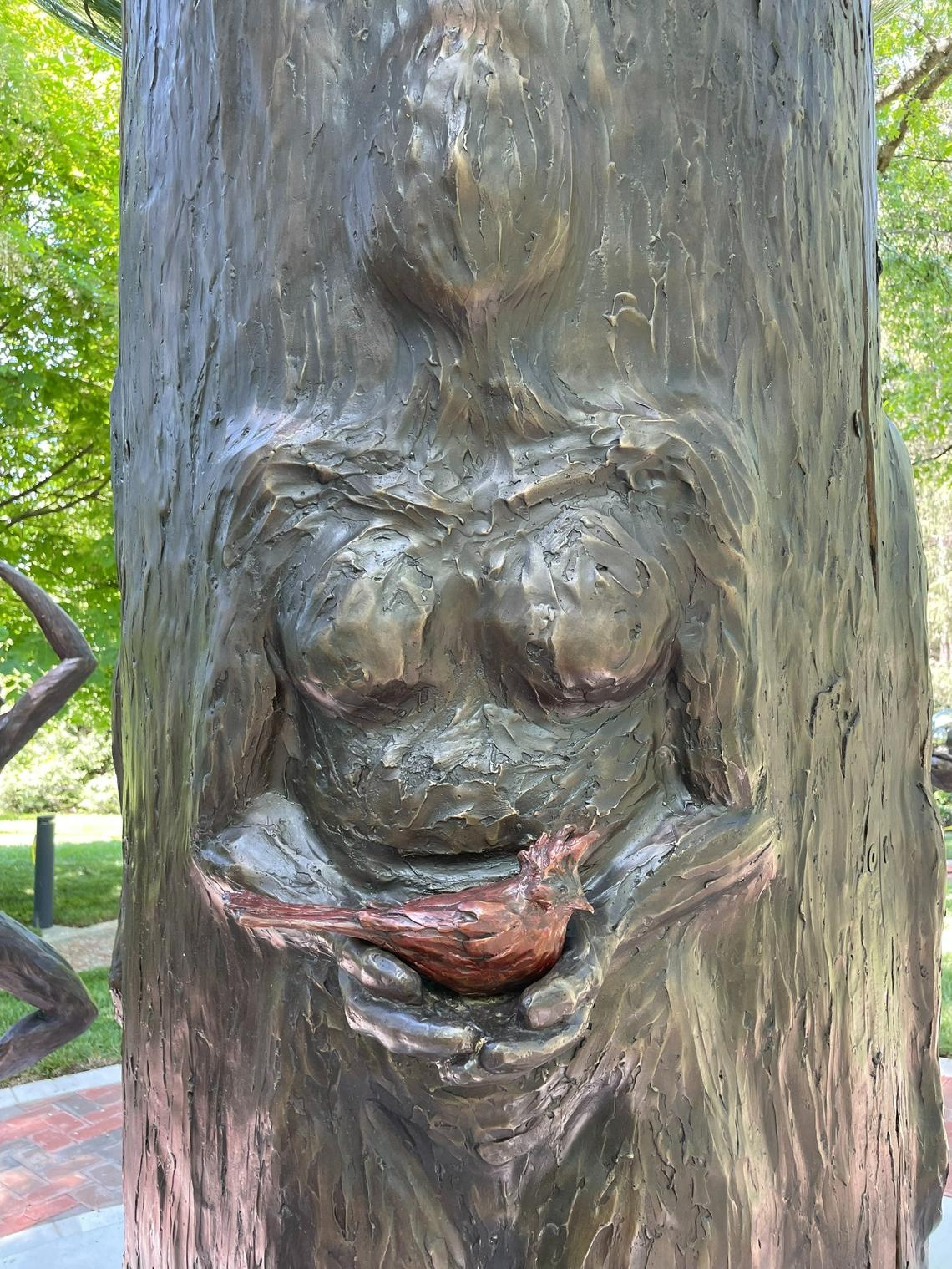 A figure in the sculpture holds a cardinal, which is Kentucky’s state bird.
