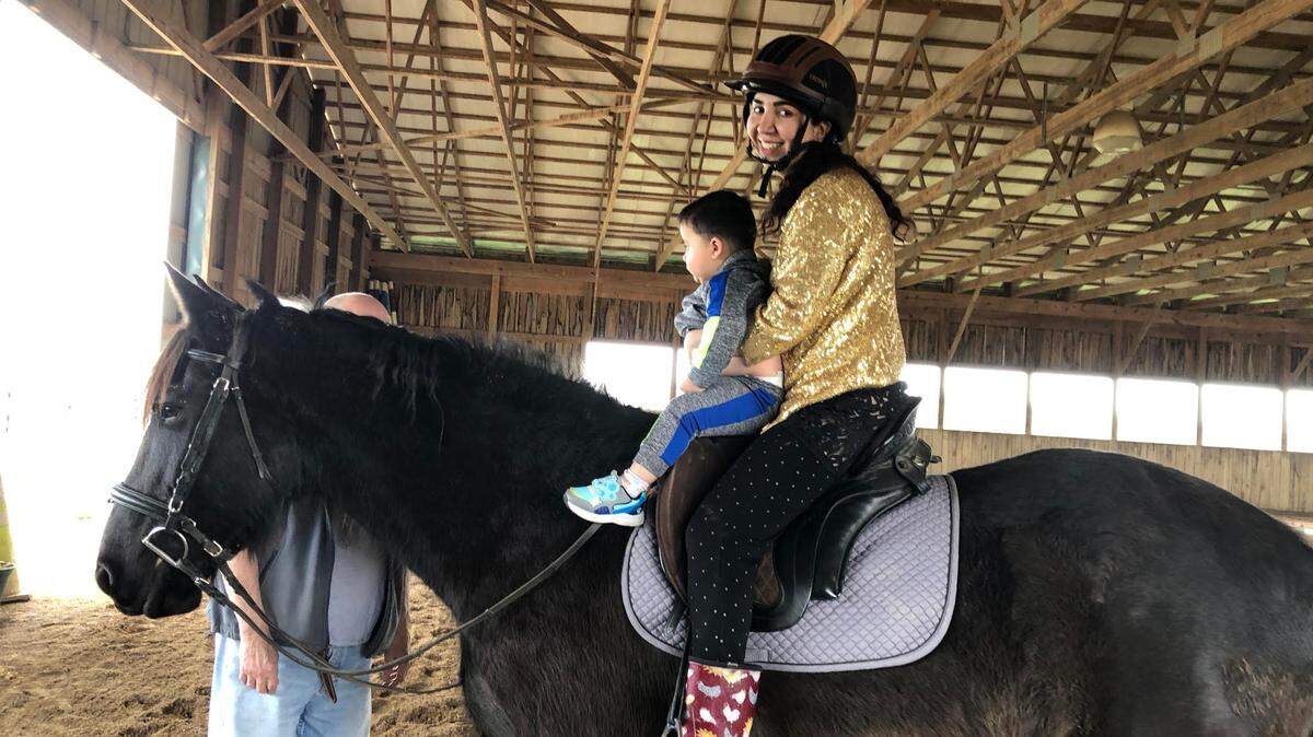 Nargis Maiwand Zafary and her son enjoying a horseback ride in Lexington.