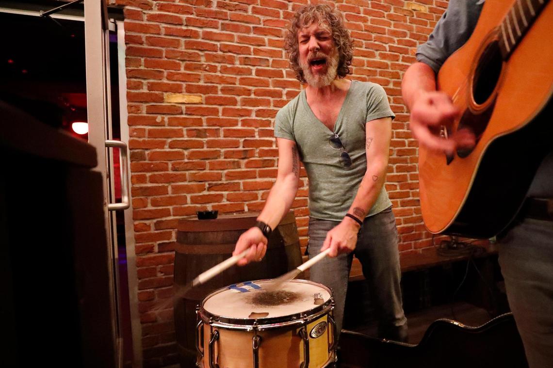 Robby Cosenza, of Lexington, Ky., drummer for the band Thirsty Boots performs with Joshua Wright, right, on the patio at Al’s Bar in Lexington, Ky., Wednesday, Oct. 14, 2020.
