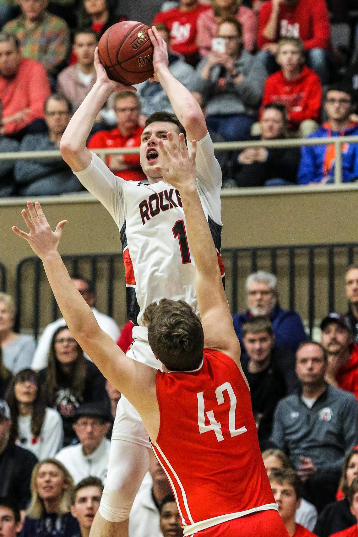 Matthew Hurt (1) of John Marshall High School in Rochester, Minn., took a shot over Lakeville North's Eli Mostaert (42) during the Section 1AAAA championship game in March.