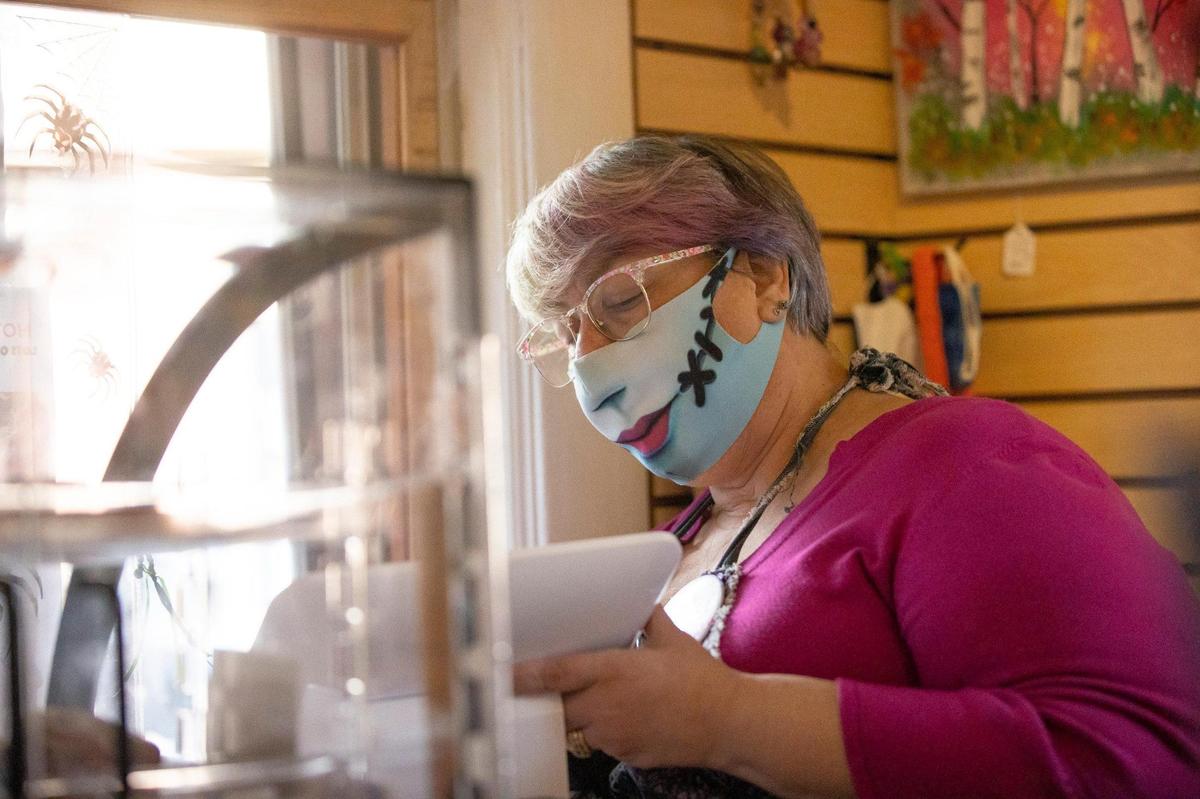 Ellie Harman, High on Art & Coffee co-owner, takes a customerÕs order at the shopÕs order window in Lexington, Ky., on Thursday, Oct. 21, 2021. Part art gallery, part cafŽ, at the intersection of creativity and coffee, it’s one of LexingtonÕs true hidden gems.
