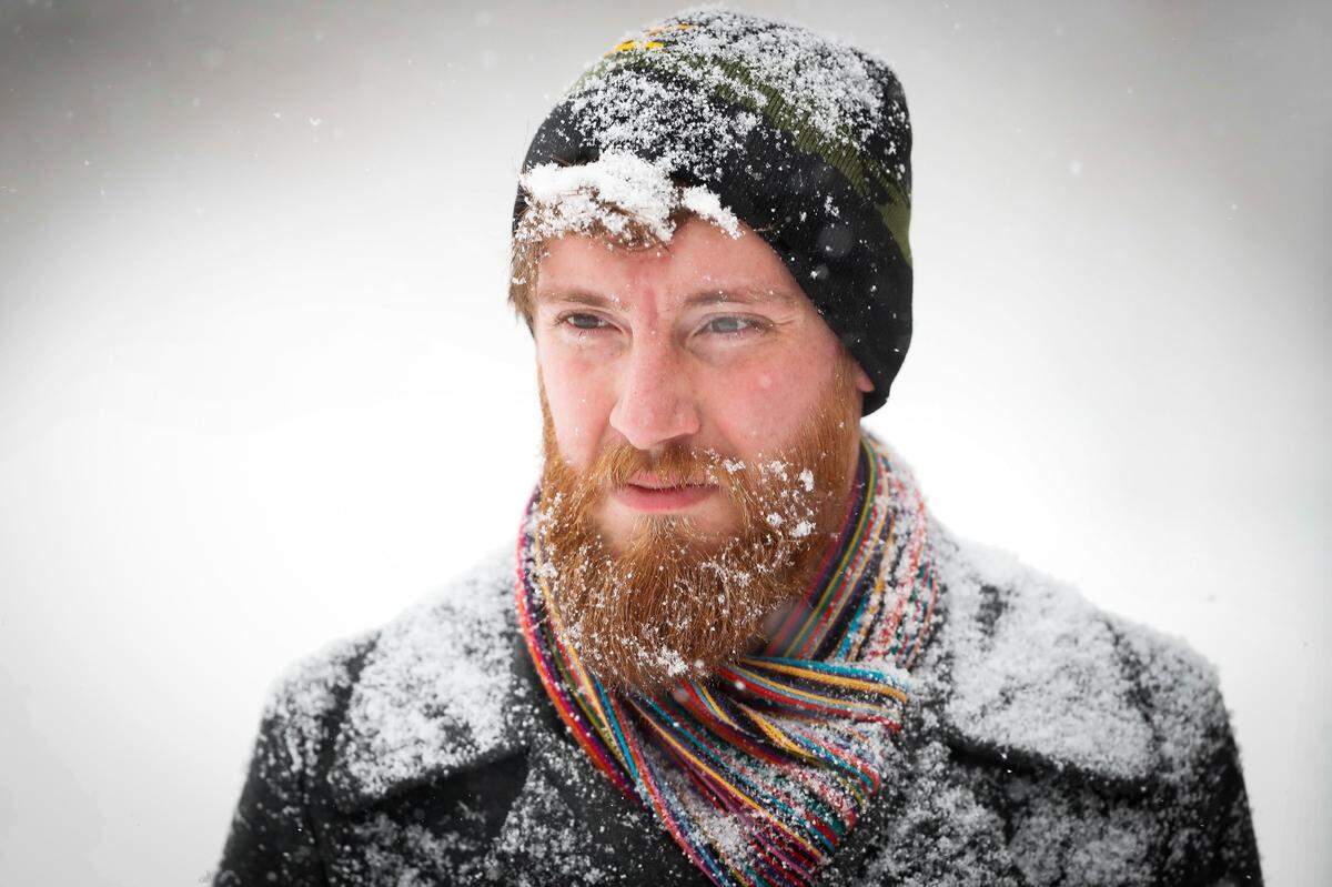 Snow accumulates on Joseph Williams Thursday, Jan. 6 as he walks home along South Ashland Avenue with drinks and food after a trip to the store.