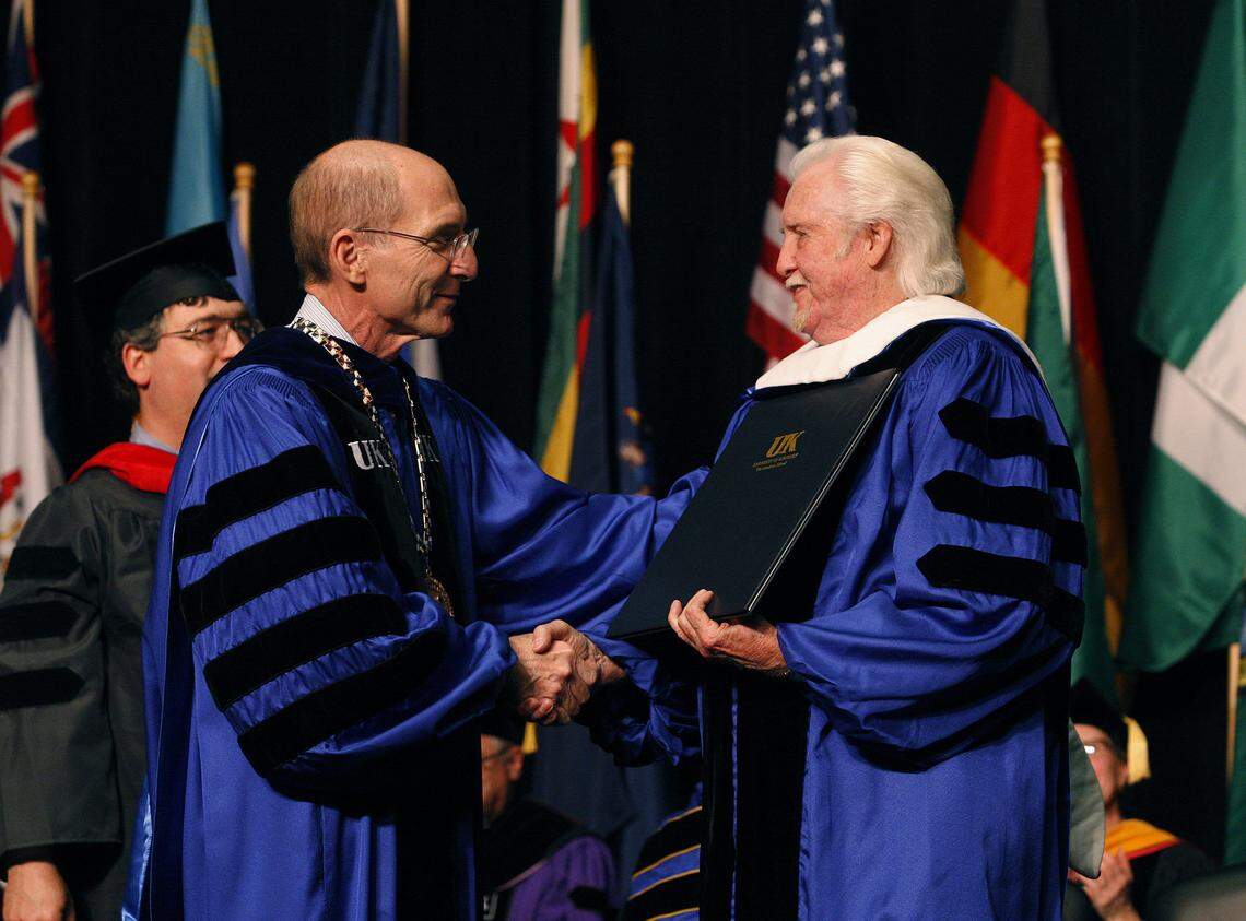 UK President Eli Capilouto, left, congratulates Grammy winner and Bluegrass music legend J. D. Crowe after conferring his honorary degree during commencement exercises for UK December graduates at Memorial Coliseum in Lexington Dec. 14, 2012. Photo by Matt Goins
