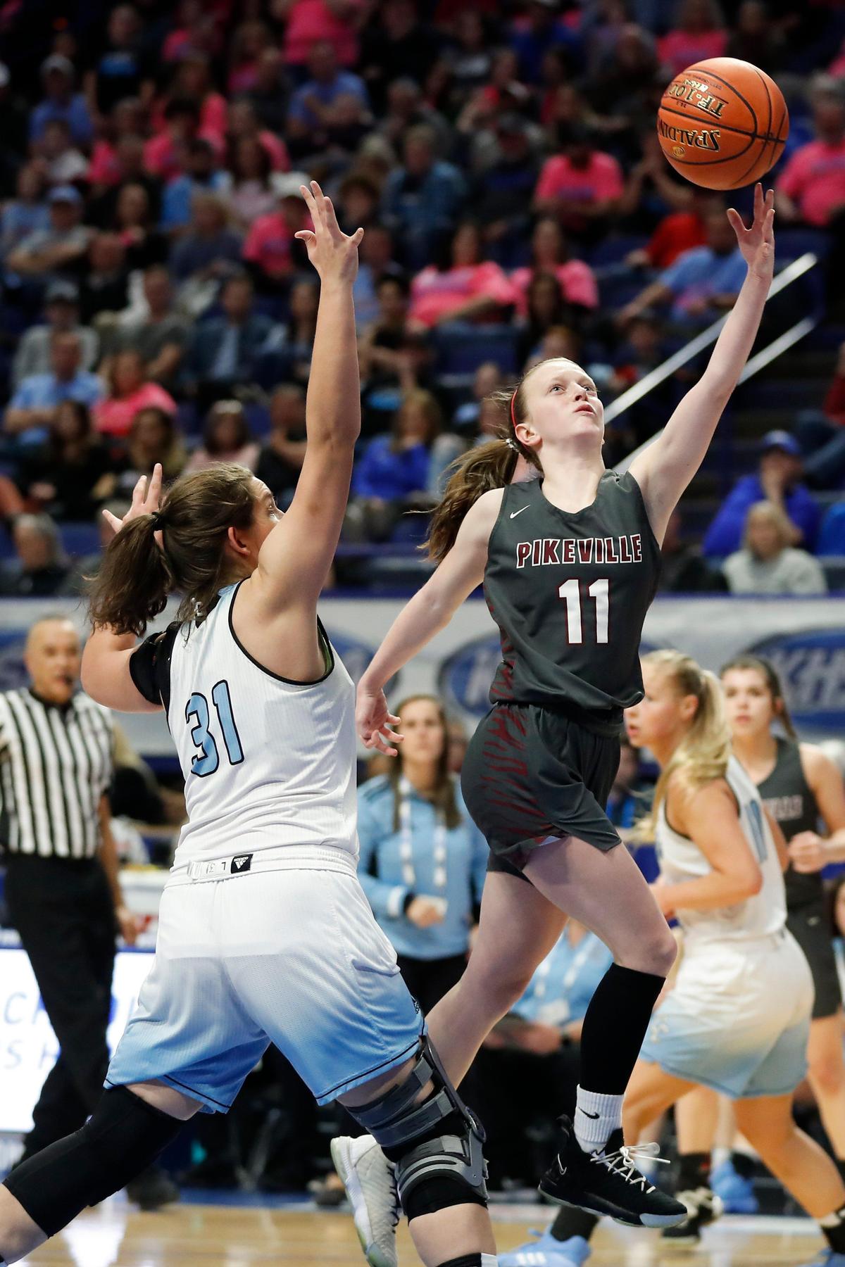 Pikeville’s Trinity Rowe (11) shoots past Casey County’s Haley Brock (31) during last year’s Sweet 16. Casey County beat Pikeville 49-46.