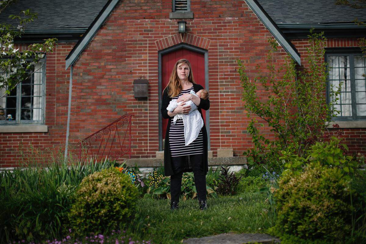Holli Schulz holds her one-week-old daughter, Dolores, in her front yard in Lexington. Worried about COVID-19, she and her husband considered a home birth, but Schulz ultimately decided against it, and had Dolores at UK Chandler Hospital.