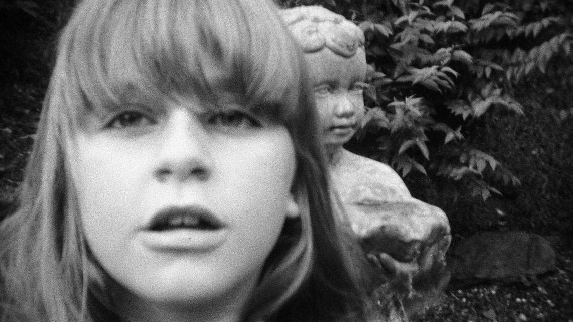 “I took a picture of myself with the statue in my backyard” is a student’s photograph.