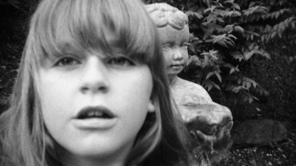 “I took a picture of myself with the statue in my backyard” is a student’s photograph.