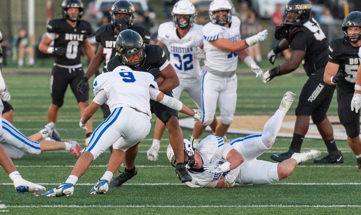 Boyle County's Darryl Yancey collides with Lexington Christian’s Collin Hensley (9) during a first-half run at the Rebel Bowl at Boyle County High School in Danville on Saturday. 